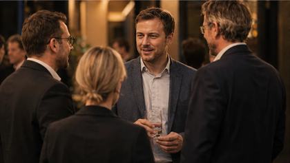 A man stands in a group of people and talks